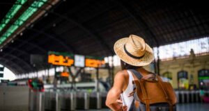 How To Travel The UK On A Student Budget Traveling girl outside train station